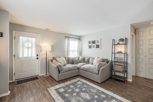 living room with dark wood-style flooring and baseboards