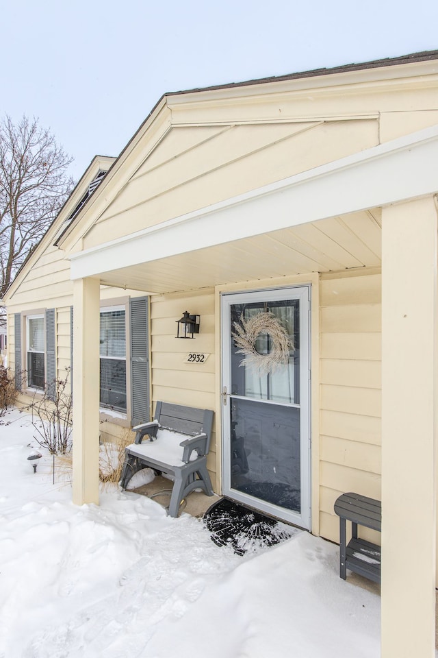 view of snow covered property entrance