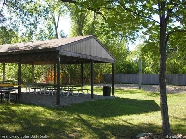 view of home's community featuring a yard, fence, and a gazebo