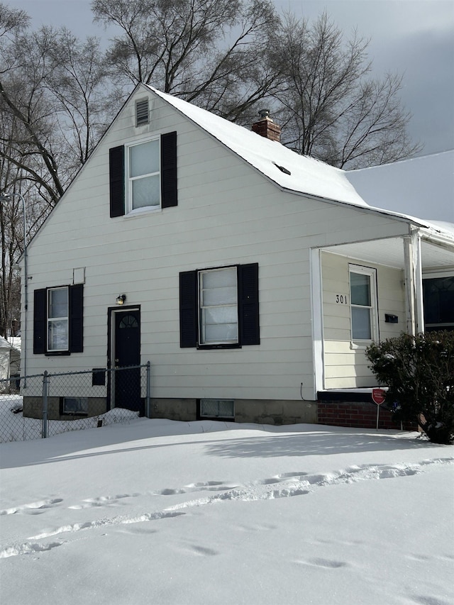 view of front of home featuring a chimney and fence