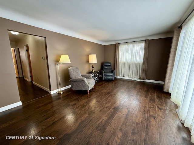 unfurnished room featuring dark wood-style flooring and baseboards