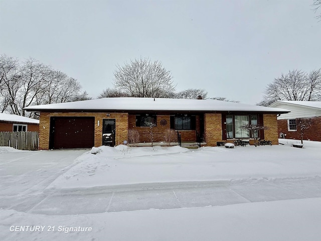 ranch-style home with a garage and brick siding