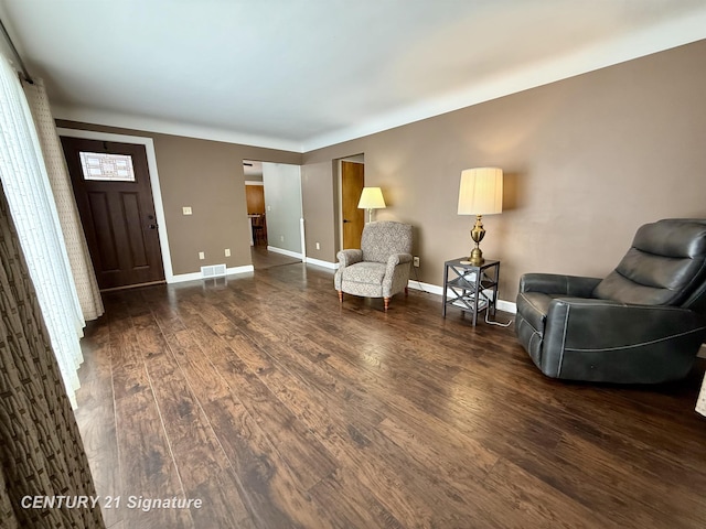 sitting room featuring dark wood finished floors, visible vents, and baseboards