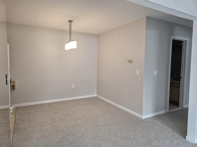 empty room with carpet floors and baseboards