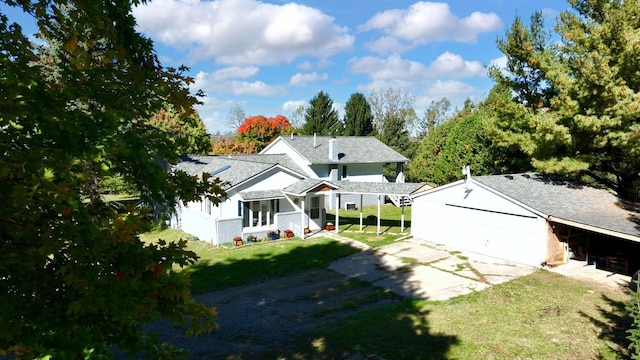 exterior space with concrete driveway and a front lawn