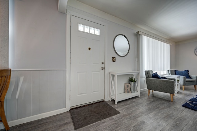 foyer entrance featuring wainscoting and wood finished floors