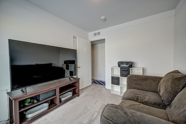 living area featuring visible vents and light carpet