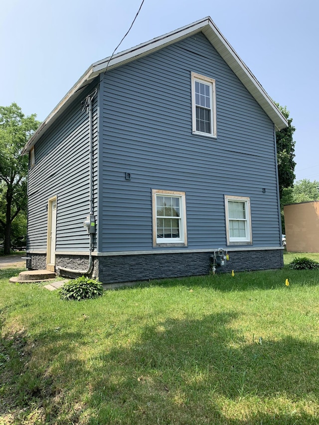 view of home's exterior with a yard