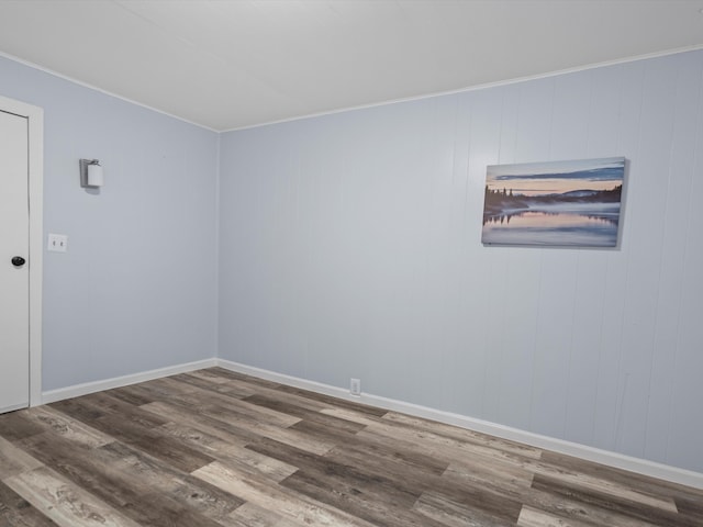 unfurnished room featuring wood finished floors and baseboards