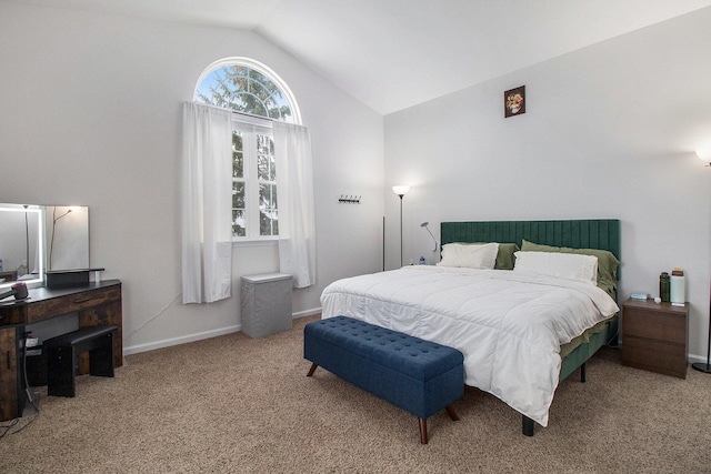 bedroom with lofted ceiling, carpet flooring, and baseboards