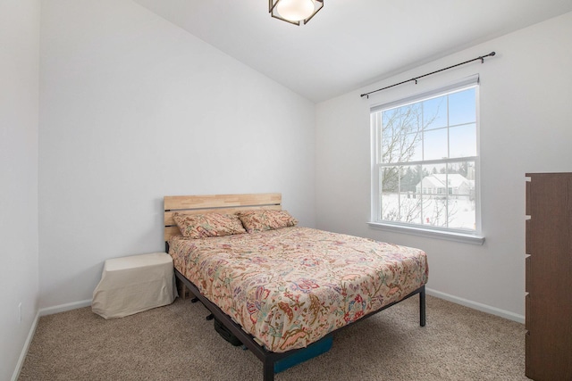 bedroom featuring carpet floors, baseboards, and vaulted ceiling