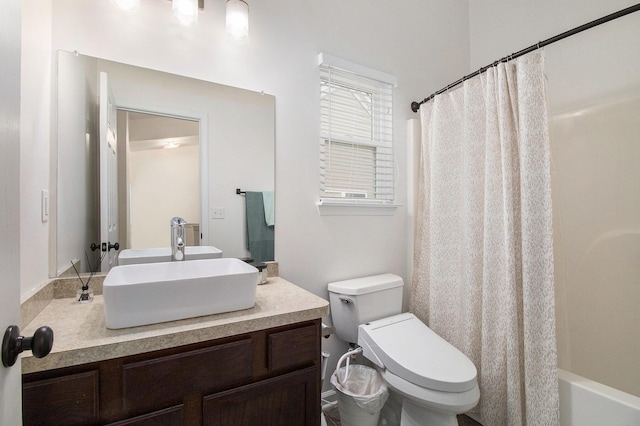 bathroom featuring vanity, toilet, and shower / bath combo with shower curtain