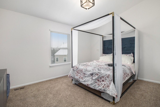 bedroom with carpet floors, visible vents, and baseboards