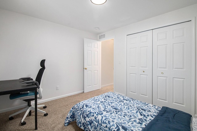 bedroom with a closet, carpet flooring, visible vents, and baseboards