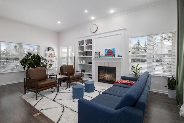 living area featuring ornamental molding, dark wood-type flooring, and plenty of natural light