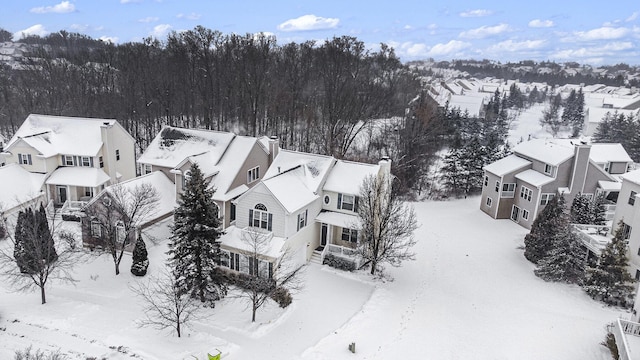 snowy aerial view featuring a residential view