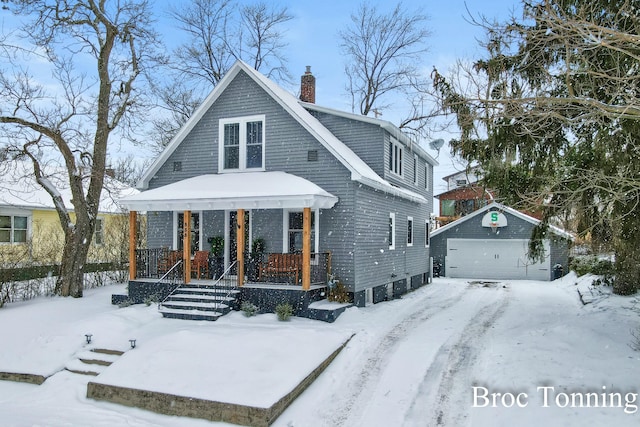 view of front of property featuring a porch, an outdoor structure, a chimney, and a garage