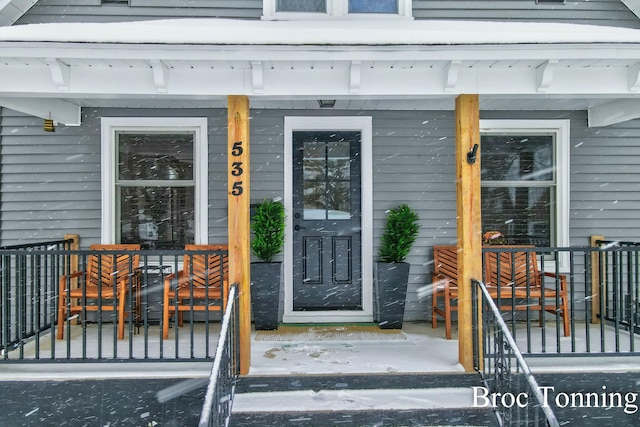 view of exterior entry with a porch