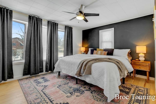 bedroom with a ceiling fan and light wood finished floors