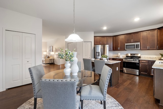 dining area with recessed lighting and dark wood-style flooring