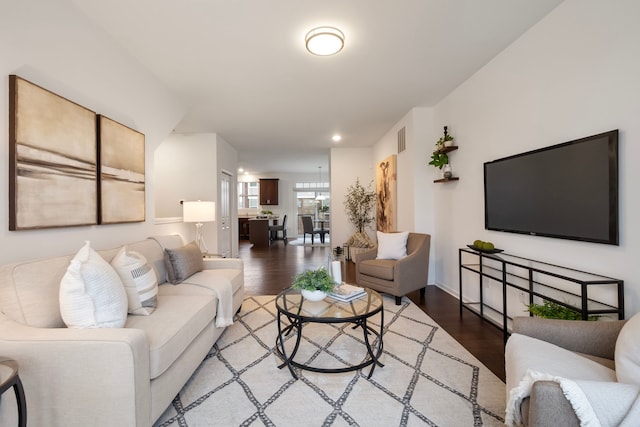 living area with visible vents, wood finished floors, and recessed lighting