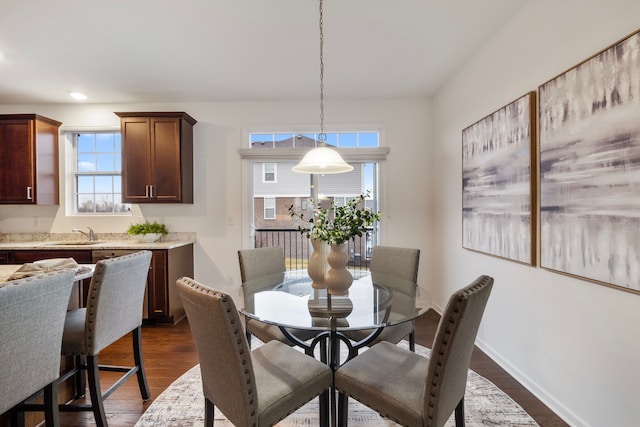 dining space featuring baseboards, dark wood finished floors, and recessed lighting