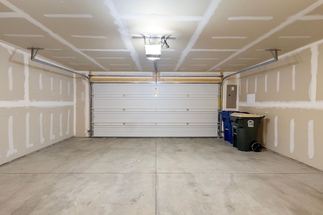 garage featuring electric panel and a garage door opener