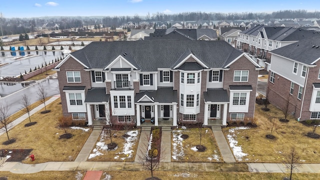 view of front facade featuring a residential view and brick siding