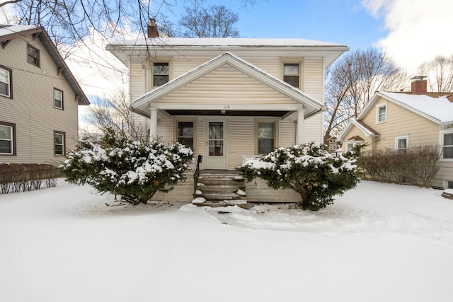 view of front of house with a porch and a chimney