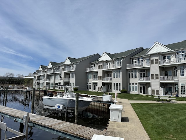 2411 Lake Ave Unit 36, Muskegon, MI 49445 - view of dock with boat lift, a water view, and a yard