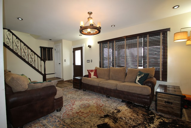 living room featuring an inviting chandelier, stairway, and recessed lighting