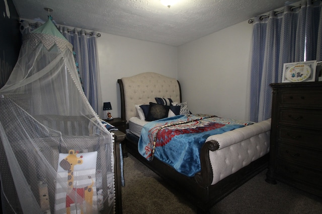 carpeted bedroom featuring a textured ceiling