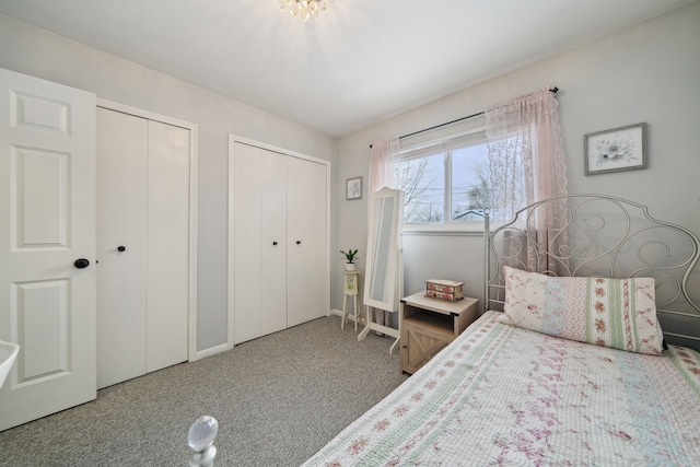 unfurnished bedroom featuring carpet and two closets