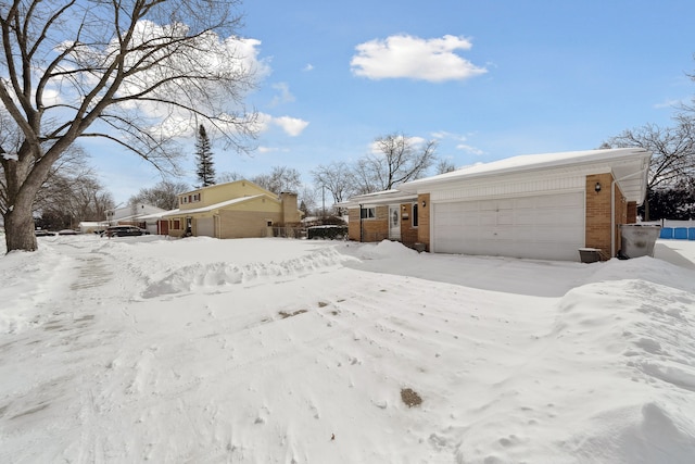 yard layered in snow with an attached garage