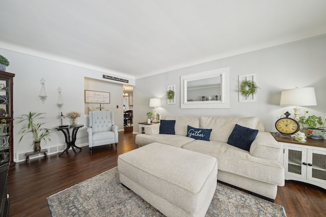 living area with visible vents, baseboards, and dark wood-type flooring