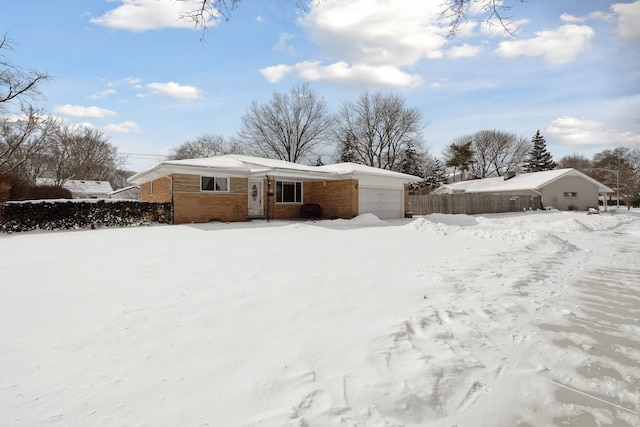 snow covered house with a garage