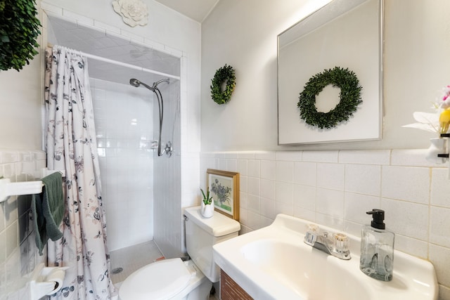 bathroom featuring toilet, a stall shower, vanity, and tile walls