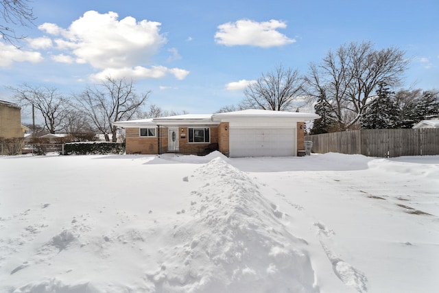 ranch-style home featuring fence and an attached garage