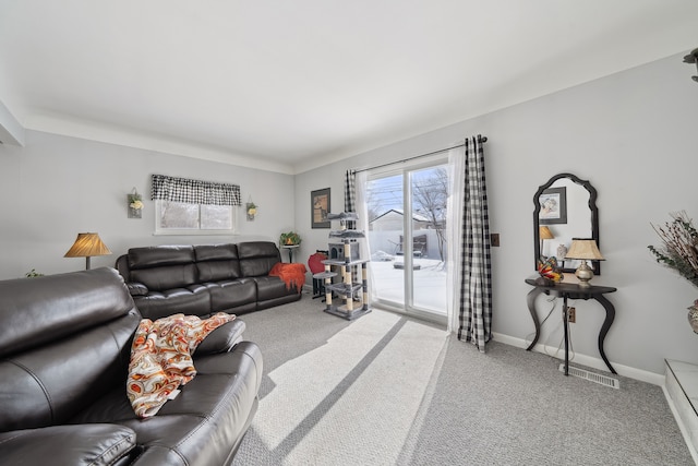 carpeted living area with baseboards