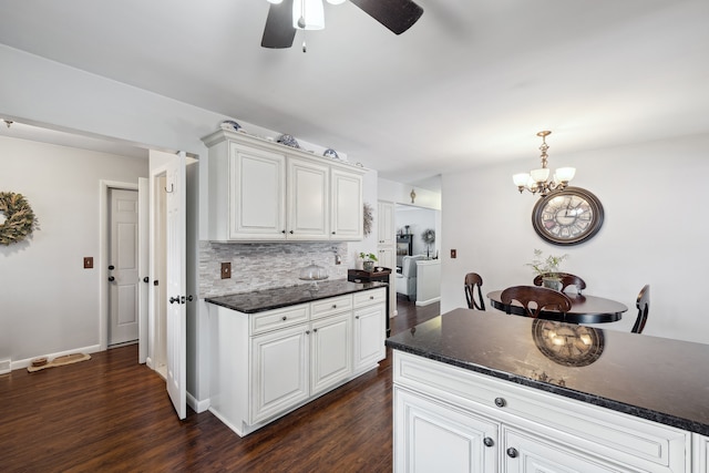 kitchen featuring tasteful backsplash, baseboards, dark wood-type flooring, decorative light fixtures, and white cabinetry