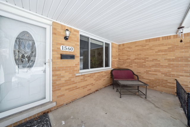 property entrance featuring brick siding