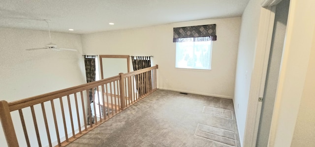 hall with recessed lighting, carpet, and baseboards