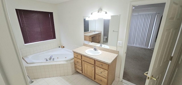 full bath with a tub with jets, tile patterned flooring, vanity, and toilet