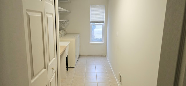 laundry area featuring laundry area, light tile patterned floors, visible vents, baseboards, and washer and dryer