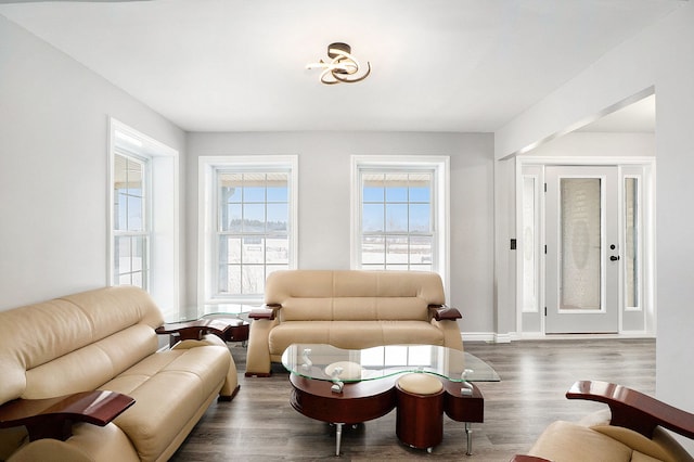 living area featuring dark wood-style flooring and baseboards