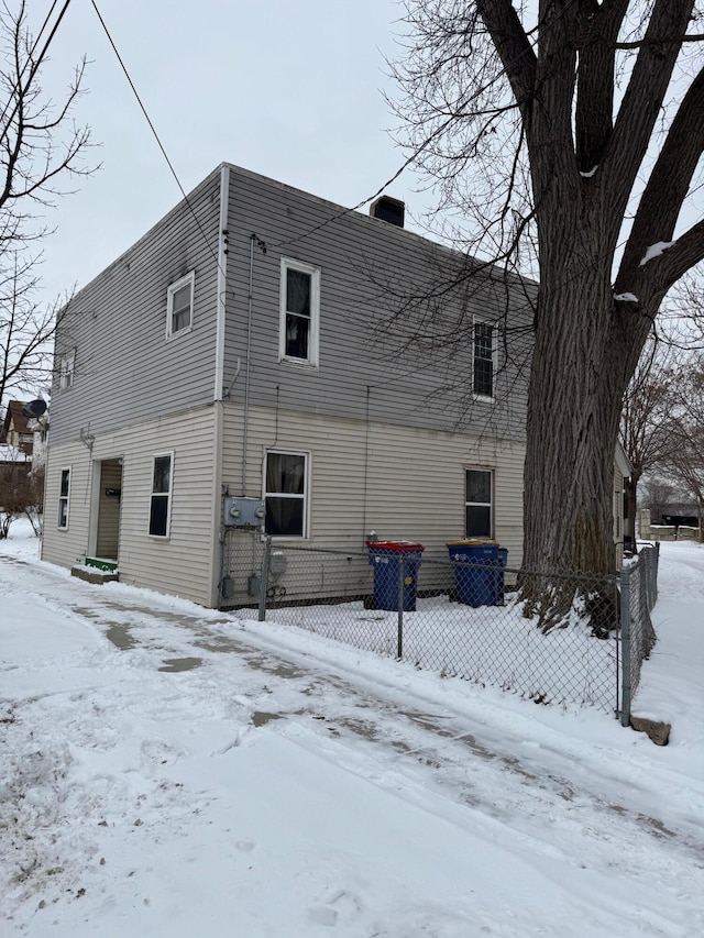 snow covered house featuring entry steps