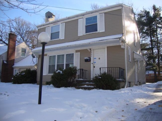 view of front of home with covered porch and a chimney