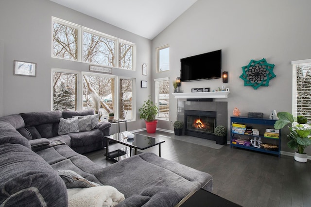 2839 Davista Dr, Highland, MI 48356 - living area featuring high vaulted ceiling, a tiled fireplace, wood finished floors, and baseboards