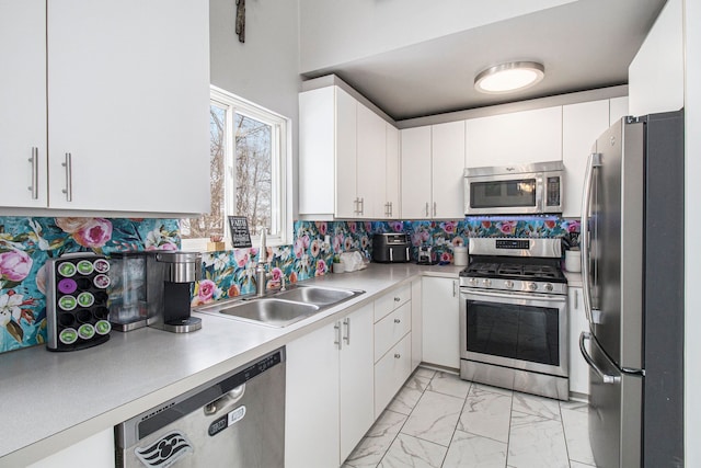 2839 Davista Dr, Highland, MI 48356 - kitchen with stainless steel appliances, light marble finish floors, a sink, light countertops, and white cabinetry