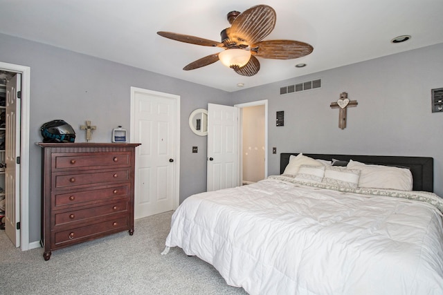 2839 Davista Dr, Highland, MI 48356 - bedroom with light colored carpet, ceiling fan, a closet, and a walk in closet